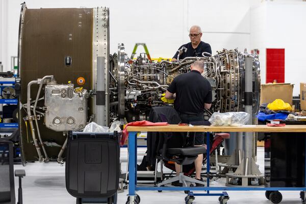 Airframe and Power Plant mechanics work on a Gear Turbine engine in Delta's new facility Tuesday, Feb. 7, 2023.  (Steve Schaefer/steve.schaefer@ajc.com)