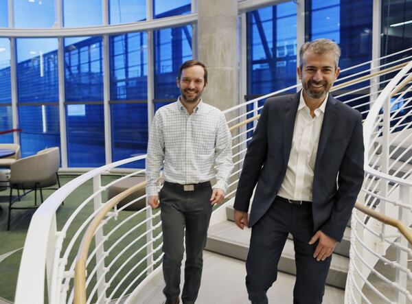 Architect Luca Maffey (right), and project manager Jonathan Mickle, from John Portman & Associates, descend the spiral staircase in the “Collaborative Core” of the Coda project at Georgia Tech. (The Coda team is still putting finishing touches on the interior and exterior of the building. The project's final look will be unveiled in May.)