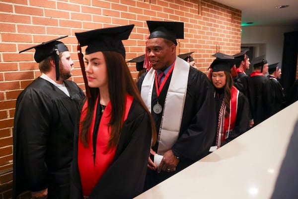 Former Georgia running back Herschel Walker lines up with fellow graduates before the fall graduation ceremony for the University of Georgia’s College of Family and Consumer Sciences, at Mahler Hall, Thursday, December 12, 2024, in Athens, Ga. (Jason Getz/AJC)
