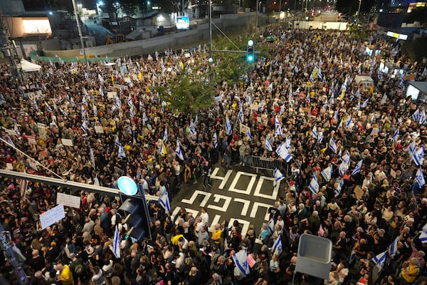 People march in a protest in Tel Aviv, Israel, Saturday, Nov. 9, 2024 against Prime Minister Benjamin Netanyahu's government and call for the release of hostages held in the Gaza Strip by the Hamas militant group, marking 400 days since their capture. (AP Photo/Ohad Zwigenberg)