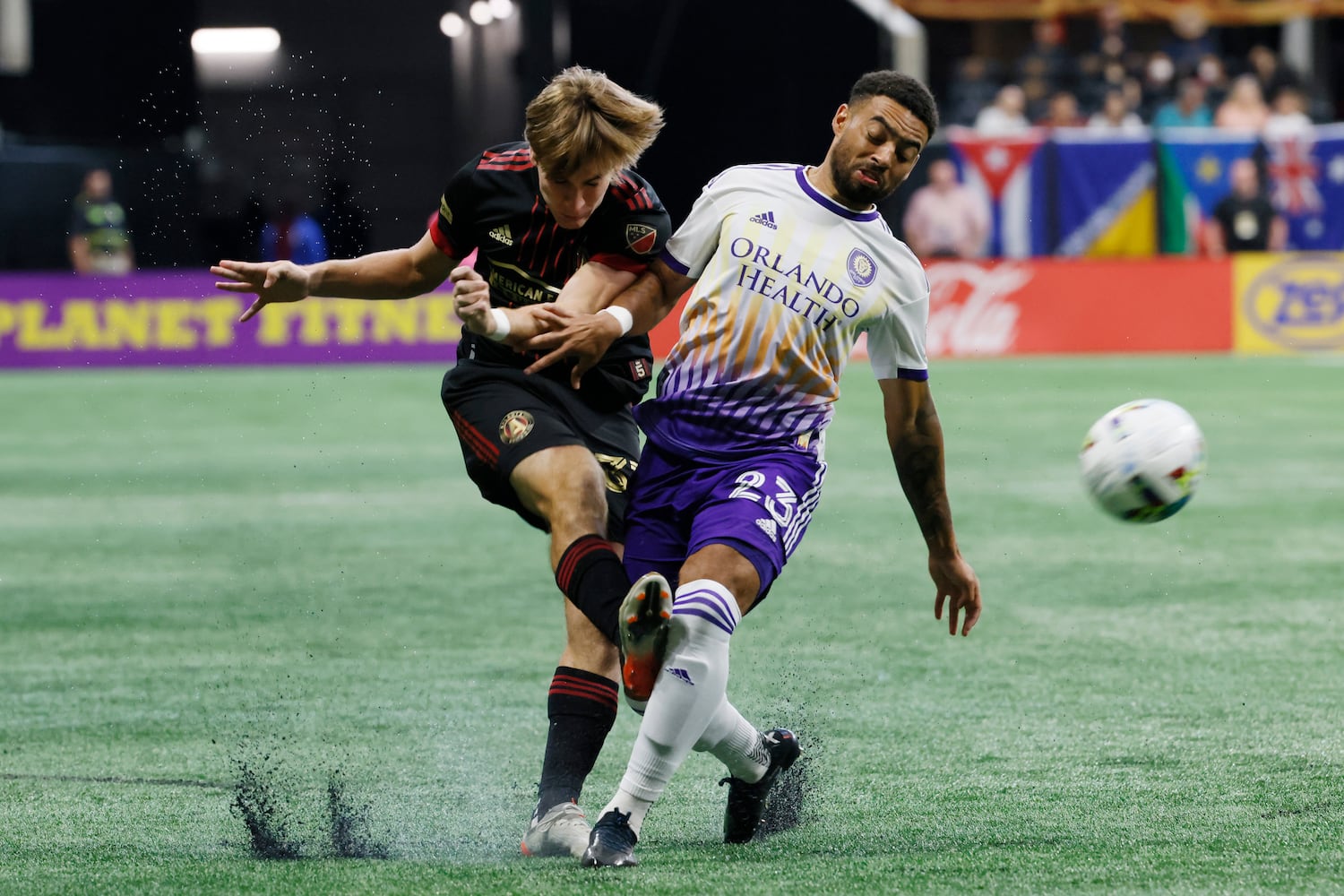 Atlanta United's Aiden McFadden takes a shot while being defended by Orlando's Jake Mulraney during the first half Sunday at Mercedes-Benz Stadium. (Miguel Martinez /Miguel.martinezjimenez@ajc.com)