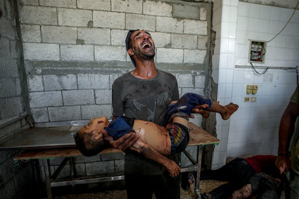 FILE - A Palestinian man mourns a relative killed in the Israeli bombardment of the Gaza Strip at a hospital morgue in Deir al-Balah on Aug. 28, 2024. (AP Photo/Abdel Kareem Hana, File)