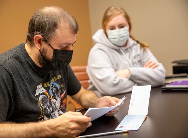 Koie Smith, left, and his wife Jennifer speak to a reporter at AbsoluteCare on Peachtree Street on Thursday, Oct 21, 2021. Koie, who suffers from long COVID, is tracking more than a dozen symptoms such as sleep, light sensitivity and speech so he can report back to his doctors.(Jenni Girtman for The Atlanta  Journal-Constitution