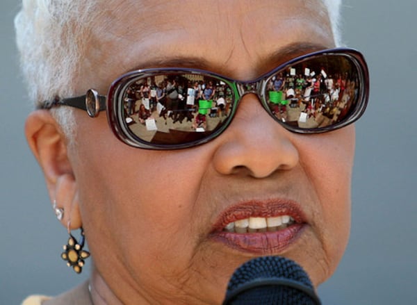 Protestors are shown in the glasses of Sen. Gloria Butler, D-Stone Mountain, as she speaks during the War-on-Women's March on the steps of the Georgia State Capitol. Around 100 people showed up for this rally.