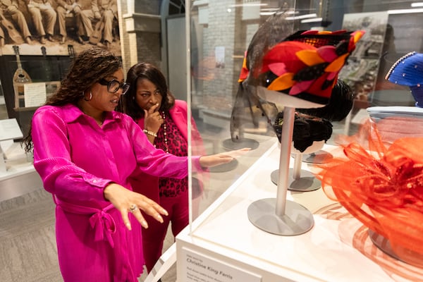 Historian La’Neice Littleton (left) and Angela Farris, an heir to the King family, look at the “Hats of the King Family Women” exhibit inside the Atlanta History Center on Monday, Feb. 10, 2025. (Arvin Temkar/AJC)