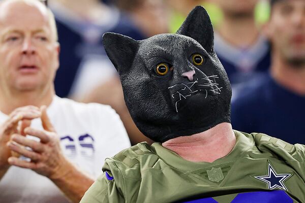 A fan wearing a black cat mask attends the game between the Minnesota Vikings and the Dallas Cowboys at AT&T Stadium on Sunday night in Arlington, Texas.