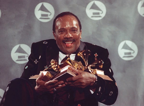 FILE - Quincy Jones cradles his Grammy awards including the album of the year award, for his eclectic album "Back on the Block" during the 33rd annual Grammy Awards, at New York's Radio City Music Hall night of Feb.20,1991. Quincy Jones died at age 91. (AP Photo/Susan Ragan, File)