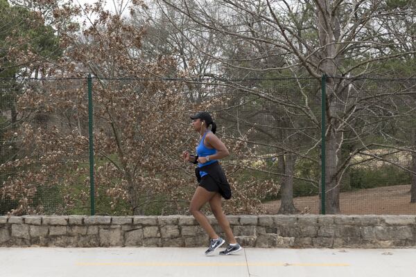 Sylvia Roulhac, 39, runs along the widened PATH trail by Chastain Park and Powers Ferry Road in Atlanta. Before the expansion, Roulhac used to have to run on the road because the path was too narrow. “It’s much better now,” Roulhac said. The PATH Foundation expanded this section of trail to accommodate two-way traffic and new pedestrian crosswalks. DAVID BARNES / SPECIAL