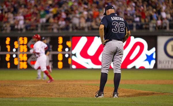 Atlanta Braves relief pitcher David Aardsma, right, hangs his head after giving up a three-run home run to Philadelphia Phillies' Freddy Galvis, left, during the sixth inning of a baseball game, Saturday, Aug. 1, 2015, in Philadelphia. (AP Photo/Chris Szagola)