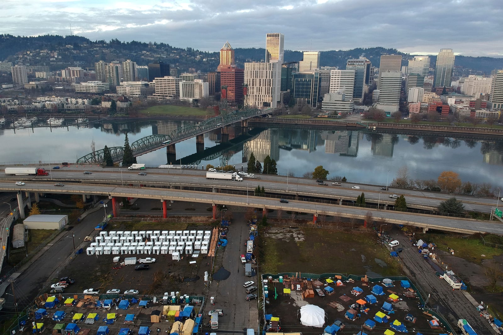 FILE - In this aerial photo, tents housing people experiencing homelessness are set up on a vacant parking lot in Portland, Ore., Dec. 8, 2020. (AP Photo/Craig Mitchelldyer, File)