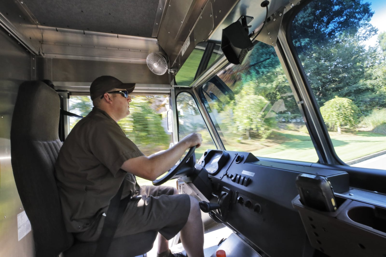 UPS driver Dan Partyka heads out on his route. It costs more to deliver items to individual doorsteps, so the rise of online shopping has forced UPS to adjust. BOB ANDRES /BANDRES@AJC.COM