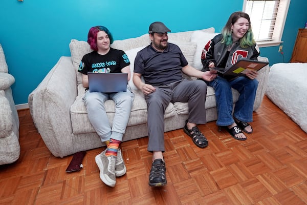 Tim Reiland, 42, center, the parent of daughter Zoe Reiland, 17, right, and Anakin Reiland, 15, photographed in Clinton, Miss., Monday, March 10, 2025, said he had no idea their previous schools, in Oklahoma, were using surveillance technology to monitor the students. (AP Photo/Rogelio V. Solis)