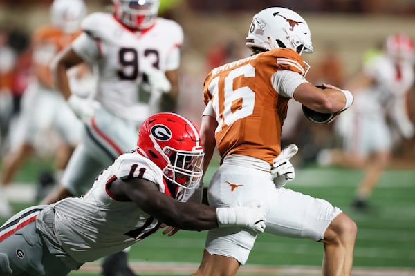 Georgia linebacker Jalon Walker (11) tackles Texas quarterback Arch Manning (16) during the second quarter at Darrel K Royal Texas Memorial Stadium, Saturday, October 19, 2024, in Austin, Tx. (Jason Getz / AJC)

