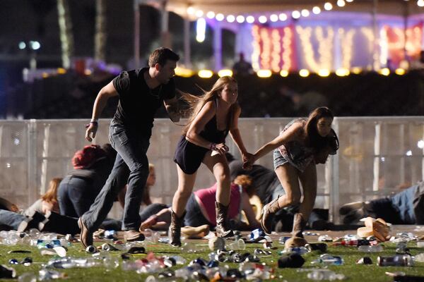 People run from the Route 91 Harvest country music festival after apparent gun fire was hear on October 1, 2017 in Las Vegas, Nevada. A gunman has opened fire on a music festival in Las Vegas, leaving at least 20 people dead and more than 100 injured. Police have confirmed that one suspect has been shot. The investigation is ongoing. (Photo by David Becker/Getty Images)