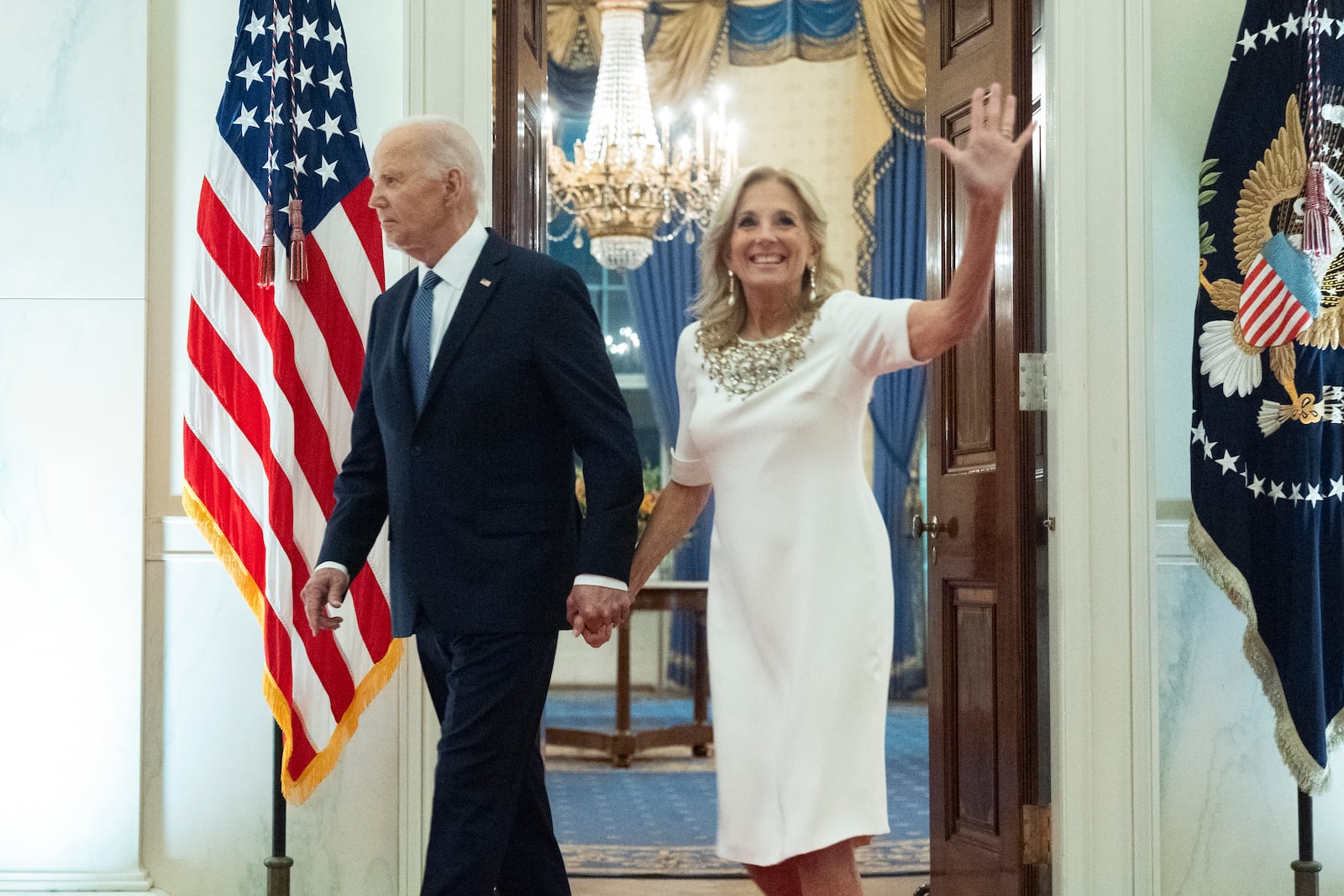 President Joe Biden and first lady Jill Biden walk from the Blue Room to join a dinner Sunday, Oct. 20, 2024, in the East Room of the White House, celebrating the new enhanced and expanded White House Public Tour being unveiled by first lady Jill Biden on Oct. 21 (AP Photo/Manuel Balce Ceneta)