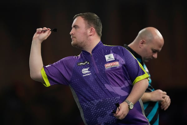 FILE - Luke Littler of England in action during the semifinal match against Scott Williams of England at the World Darts Championship, in London, Tuesday, Jan. 2, 2024. (AP Photo/Kin Cheung, File)