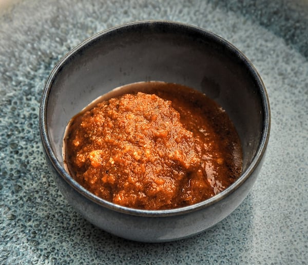 Sun-Dried Tomato Pesto, one of the elements of the Burgess Wedge Salad from Fia, should be placed on the side of the salad. (Styling by chef Matt Meacham / Chris Hunt for the AJC)