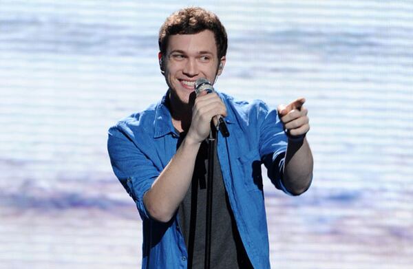 FILE - In this May 9, 2012 file photo provided by Fox, contestant Phillip Phillips performs on the singing competition series "American Idol," in Los Angeles. With the eleventh season finale of "American Idol" just a week away, many fans of the Fox talent contest aren't wondering who will capture the title, but whether sassy 16-year-old diva-in-training Jessica Sanchez or booming 20-year-old vocal showstopper Joshua Ledet would even have the votes to beat bluesy 21-year-old front-runner Phillip Phillips. (AP Photo/Fox, Michael Becker, File)