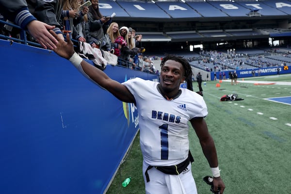 Pierce County running back DJ Bell (1) celebrates with fans after scoring the game-winning touchdown in overtime to win 13-7 against Oconee County during the Class 3A state high school football final at Center Parc Stadium Wednesday, December 30, 2020 in Atlanta. JASON GETZ FOR THE ATLANTA JOURNAL-CONSTITUTION






