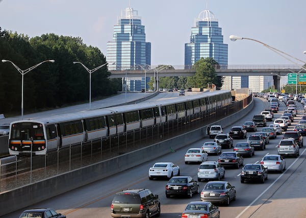 A MARTA train makes its way North past Ga. 400 traffic. Bus Rapid Transit service is planned to speed commuters along Ga. 400. BEN GRAY / AJC FILE PHOTO