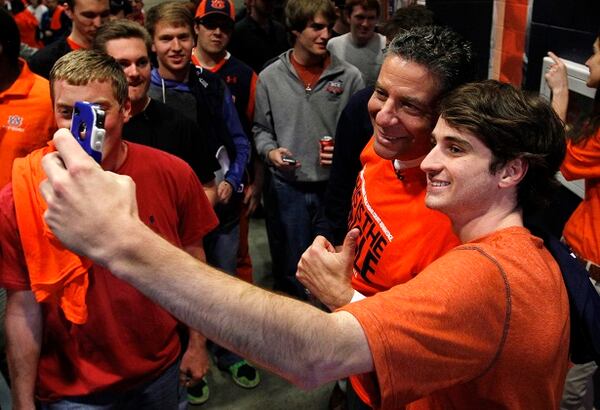 Baylor Cocke, of Birmingham, takes a selfie with Auburn's new men's basketball coach, Bruce Pearl, on Tuesday, March 18, 2014, in Auburn, Ala. (AP Photo/Butch Dill) The new Auburn coach poses for a selfie. (Bruce Dill/AP)