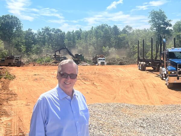 Ed Whitehouse stands on a plot of land in Butts County, Georgia. He consults for a local company called Interstate Health Systems, which is clearing the land to build medical office buildings, potentially to lure providers to this rural community. (Andy Miller for KFF Health News)