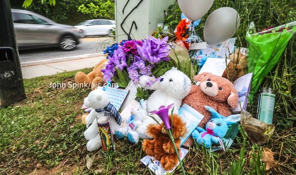 Friends and neighbors left flowers and plush toys at a memorial for 15-year-old Diamond Johnson, who was fatally shot near an Atlanta shopping plaza.