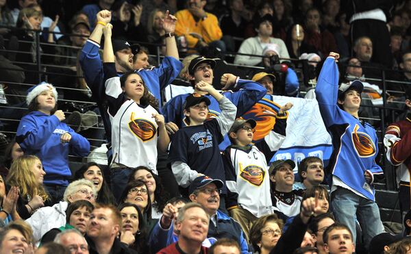 101230 Atlanta : Atlanta Thrashers fans celebrate their shootout victory over the Boston Bruins at Philips Arena on Thursday, Dec. 30, 2010. Thrashers won 3 - 2 over Bruins after the shootout. Hyosub Shin, hshin@ajc.com 
