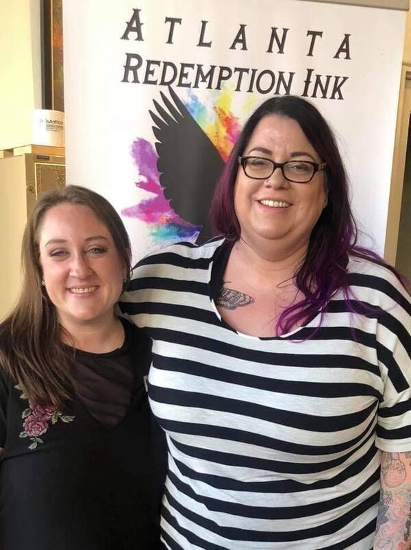 Jessica Lamb, founder of Atlanta Redemption Ink, with Crystal Boyd, of Pür Ink in Alpharetta. Boyd has done several tattoo covers for the nonprofit. CONTRIBUTED