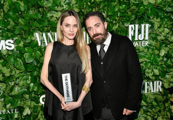 Actor Angelina Jolie, left, poses with the performer tribute award for her role in "Maria" with filmmaker Pablo Larrain during The Gothams Film Awards at Cipriani Wall Street on Monday, Dec. 2, 2024, in New York. (Photo by Evan Agostini/Invision/AP)