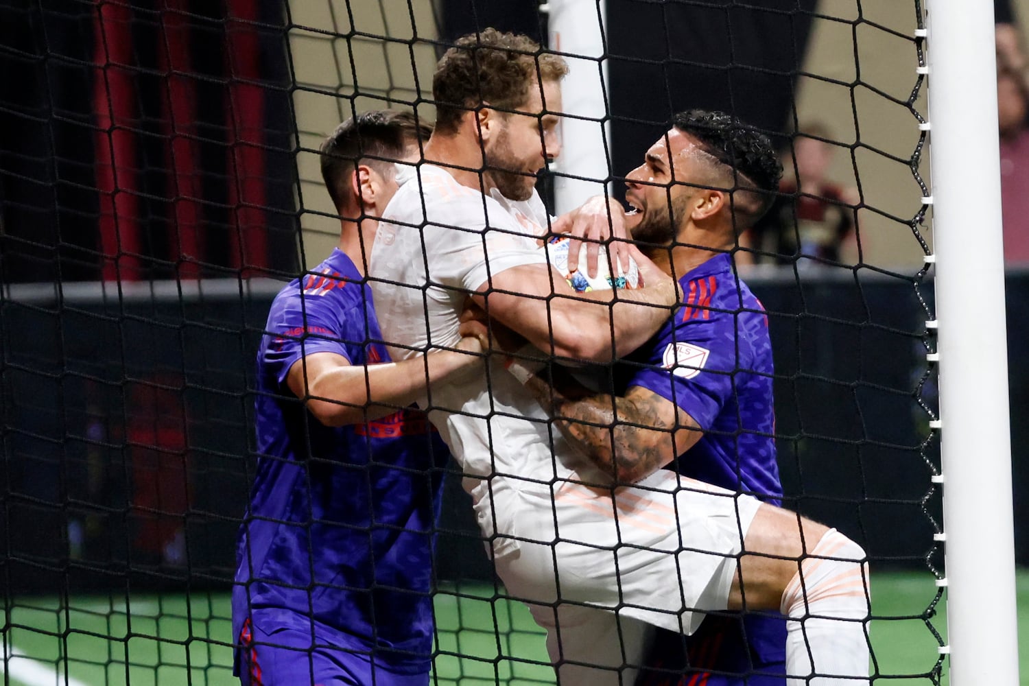 Atlanta United attacker Dom Dwyer (4) fights for the ball against a Columbus Crew player after scoring the team's first goal during the second half of an MLS soccer match on Saturday, May 28, 2022. Miguel Martinez / miguel.martinezjimenez@ajc.com