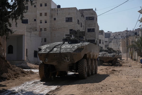 Israeli army vehicles are seen during a military operation in the West Bank city of Jenin, Tuesday, March 11, 2025. (AP Photo/Majdi Mohammed)