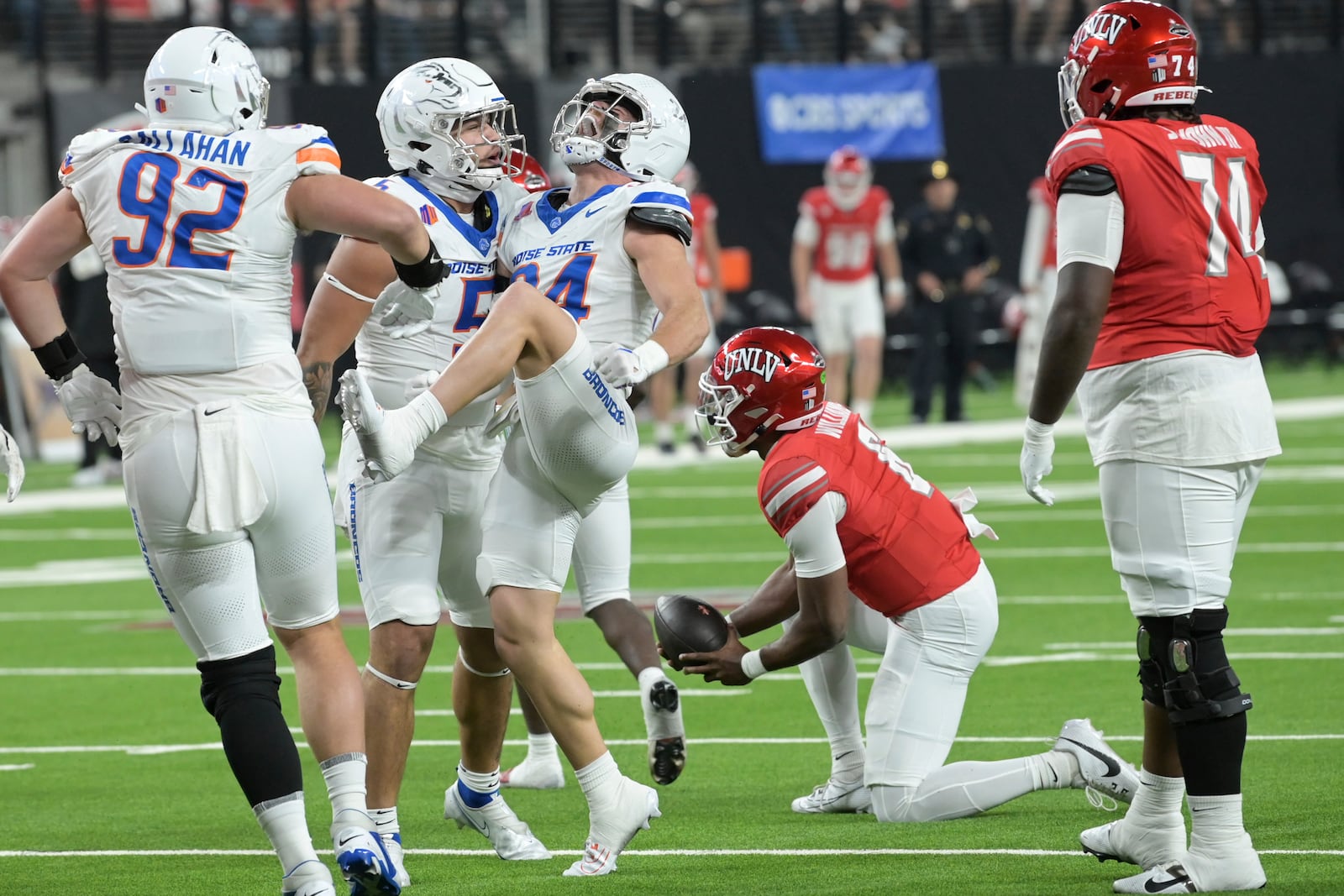 Boise State safety Alexander Teubner (34) celebrates sacking UNLV quarterback Hajj-Malik Williams (6) during the first half of an NCAA college football game Friday, Oct. 25, 2024, in Las Vegas. (AP Photo/Sam Morris)