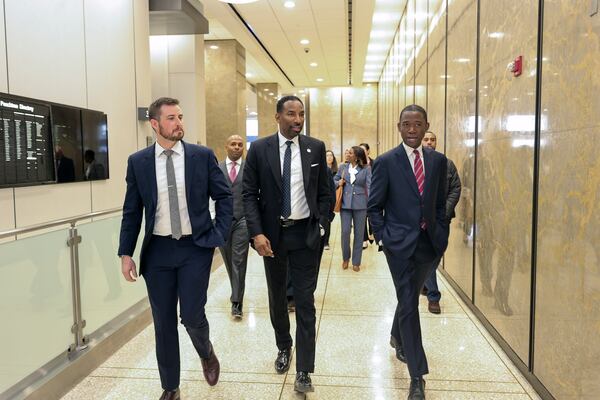 (Left to right) Senior policy advisor to the mayor Joshua Humpries, Mayor Andre Dickens and U.S. Department of Treasury Deputy Secretary Wally Adeyemo walk through the lobby of Two Peachtree Street on Tuesday, Dec. 12, 2023.  The city plans to turn the 41-story building into a mixed-income, mixed-use space that will hold hundreds of housing units. (Natrice Miller/ Natrice.miller@ajc.com)