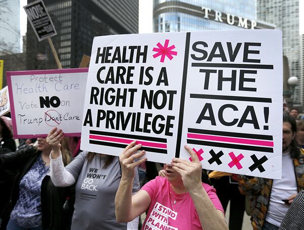 Protesters gather across the Chicago River from Trump Tower to rally against the repeal of the Affordable Care Act Friday, March 24, 2017, in Chicago. Earlier, President Donald Trump and GOP leaders yanked their bill to repeal "Obamacare" off the House floor Friday when it became clear it would fail badly.