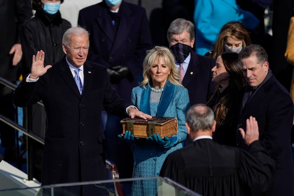 President Joe Biden takes the oath of office from Supreme Court Chief Justice John Roberts as his wife, first lady Jill Biden, stands next to him during the 59th presidential inauguration in Washington, D.C., on Wednesday, Jan. 20, 2021. (Kent Nishimura/Los Angeles Times/TNS)