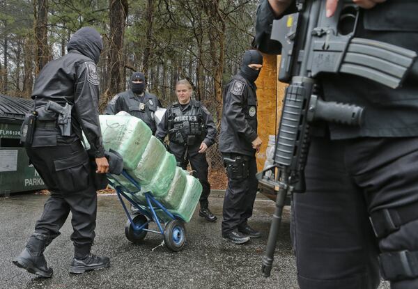 Jan. 10, 2014 DeKalb County: Undercover officers load seized drugs back into storage unit at police headquarters following the press conference Friday. DeKalb County Police were busy last year fighting the war on drugs. Friday, DeKalbâ€™s Public Safety Deputy Chief Operating Officer Cedric Alexander was flanked by masked undercover narcotics officers, drug-sniffing dogs and detectives when he announced that more than $128 million in drugs had been confiscated in 2013 on Friday, Jan. 10, 2014. Included in the amount of drugs taken off the street were 302 kilograms of methamphetamine, 6,000 pounds of marijuana, 565 kilograms of powder cocaine, and 1 kilogram of crack cocaine, police said. Drug investigators also seized $3.4 million in cash. DeKalb narcotics detectives said many traffickers carry illicit drugs in secret compartments created in the vehicles they drive. Either in hollowed out dashboards or floor boards, traffickers can hide up to 100 kilograms of illegal products, or cash and guns without immediate detection. Alexander said police are working with federal and state authorities to curtail drug trafficking by cartels, who have targeted the metro Atlanta area as a hub for moving narcotics to other areas of the nation. JOHN SPINK/JSPINK@AJC.COM