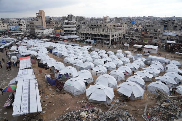 A sprawling tent camp for displaced Palestinians sits adjacent to destroyed homes and buildings in Gaza City, Gaza Strip, Saturday, March 1, 2025 during the Muslim holy month of Ramadan. (AP Photo/Abdel Kareem Hana)