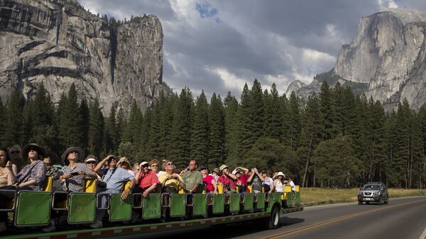 FILE â Tourists ride through Yosemite National Park in California, Aug. 27, 2013. Advance planning may be in order if you want to camp at a popular national park or ride the latest roller coaster. (Max Whittaker/The New York Times)