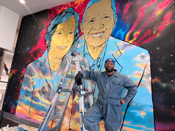 Artist Fabian Williams in front of his work, titled "Well Done Good and Faithful Servant, The Carters."