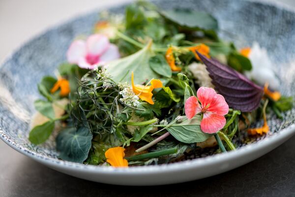 The Asian-style shrimp pancake at Cold Beer shows up covered with bitter lettuces, herbs and flowers. CONTRIBUTED BY MIA YAKEL