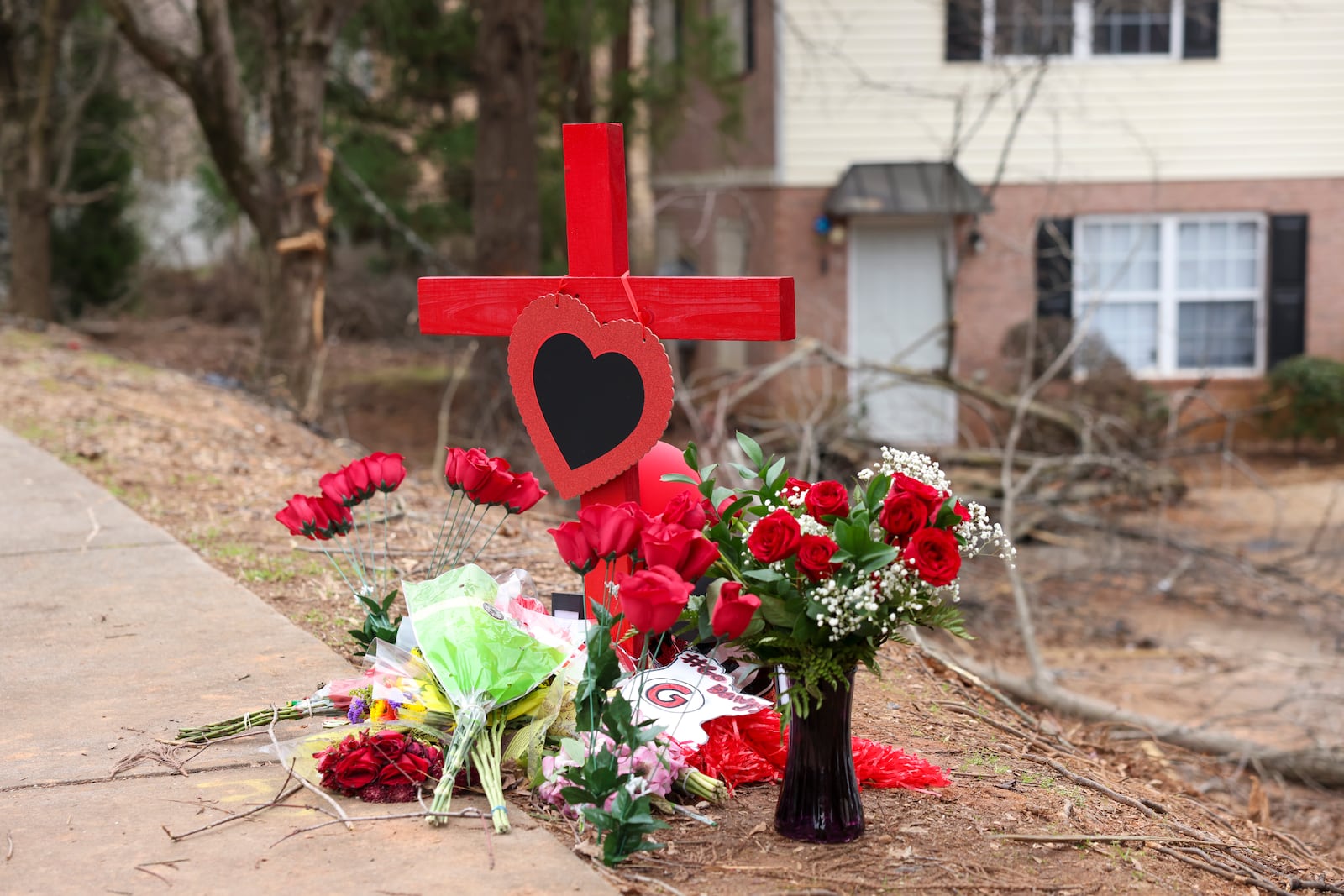 A memorial is set up for University of Georgia football player Devin Willock and UGA football team staff member Chandler LeCroy at the site where their vehicle crashed on Barnett Shoals Rd, Saturday, Jan. 21, 2023, in Athens, Ga.. Willock and LeCroy died from their injures caused from the Sunday morning accident, Jan. 15, 2023. Two other passengers were injured. Jason Getz / Jason.Getz@ajc.com)
