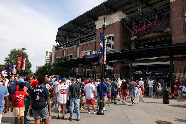 Atlanta Braves fans wait in line outside of the third base gate at Truist Park, Tuesday, August 6, 2024, in Atlanta. Fans waited in line for the gates to open to receive an OutKast bobblehead, featuring duo Big Boi and Andre 3000. The first 15,000 fans received this bobblehead. (Jason Getz / AJC)
