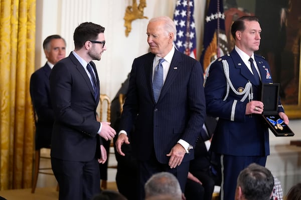 President Joe Biden, center, presents the Presidential Medal of Freedom, the Nation's highest civilian honor, to Alex Soros, left, on behalf of his father George Soros, in the East Room of the White House, Saturday, Jan. 4, 2025, in Washington. (AP Photo/Manuel Balce Ceneta)