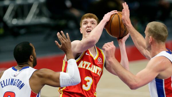 Hawks guard Kevin Huerter (center) goes to the basket against Pistons defenders Wayne Ellington,( left)  and Mason Plumlee during the first quarter Monday, April 26, 2021, in Detroit. (Duane Burleson/AP)