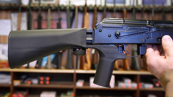 A bump stock device (left) that fits on a semi-automatic rifle to increase the firing speed, making it similar to a fully automatic rifle, is installed on a AK-47 semi-automatic rifle (right) at a gun store on October 5, 2017, in Salt Lake City, Utah.