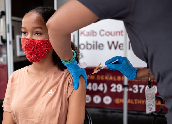 Kadence Booker,13, gets a COVID-19 vaccination at a mobile clinic at Decatur High School on Monday afternoon, July 19, 2021. (Ben Gray for the Atlanta Journal-Constitution)