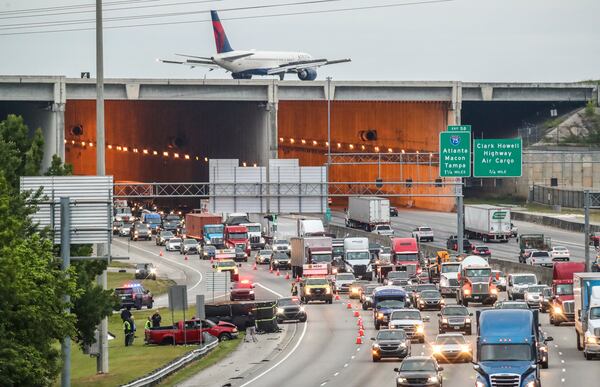 April 26, 2023 Clayton County: A single-vehicle fatal crash investigation on I-285 West closed an exit ramp heading toward Hartsfield-Jackson International Airport for hours Wednesday morning, April 26, 2023. (John Spink / John.Spink@ajc.com)

