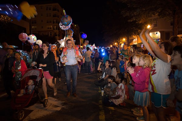 Spectators line East Ponce De Leon Avenue during a past Decatur Lantern Parade. STEVE SCHAEFER / SPECIAL TO THE AJC