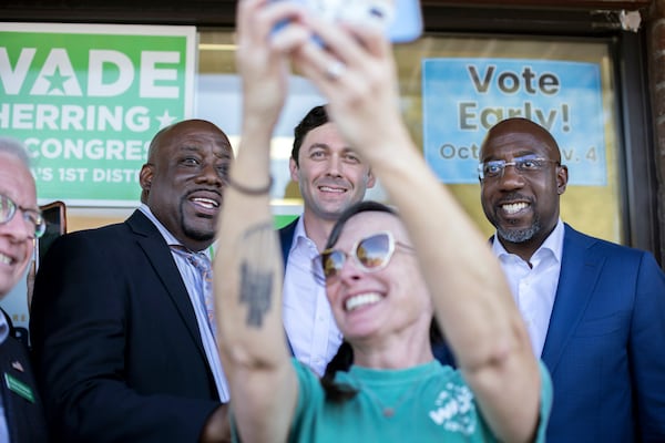 SAVANNAH, GA - OCTOBER 25, 2022:  Jessica Leigh Lebos, bottom center, take a selfie with Georgia Democratic Senate candidate Raphael Warnock, right, Sen. Jon Ossoff (D-Ga), center top, and Savannah Mayor Van Johnson, left, after Warnock spoke with supporters in front of a canvassing office Tuesday, Oct. 25, 2022, in Savannah, Ga. (AJC Photo/Stephen B. Morton)